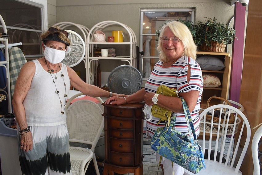 Carol Peschel stands with Mary Theall and the jewelry cabinet she bought.