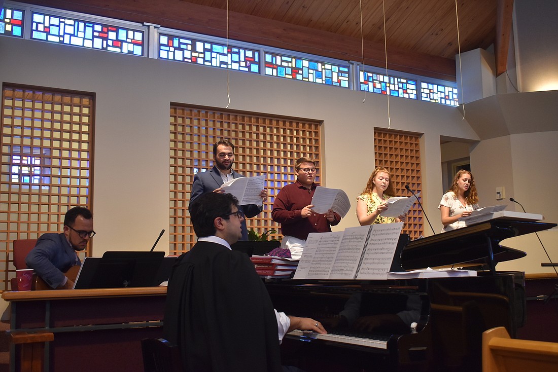 Michael Bodnyk leads the choral scholars in rehearsal.