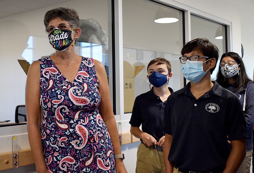 Joanne Barrett, the middle school instructional technology teacher, takes eighth graders Sequoia Miller, Noah Knego and Izabella DeToma through the new middle school facility.