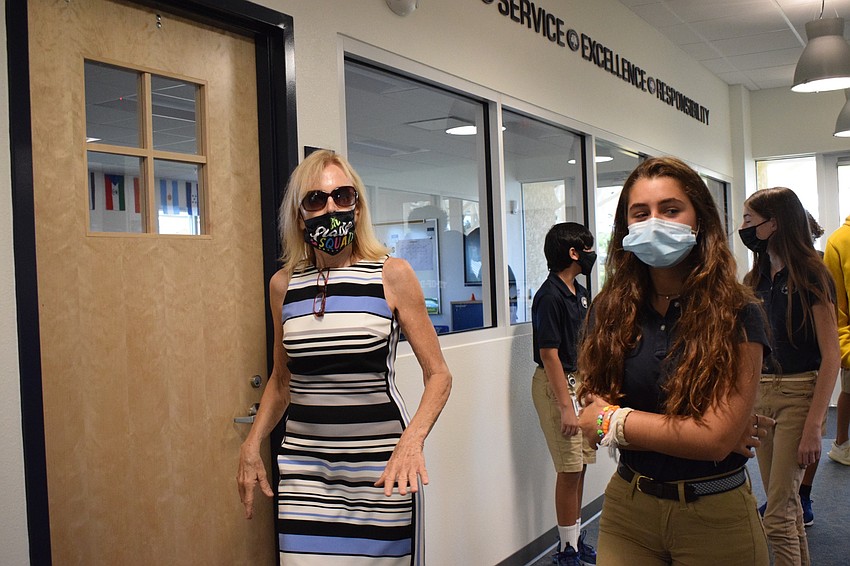English teacher Kathy Dozier shows eighth grader Lila Tack and other students around the new facility. 