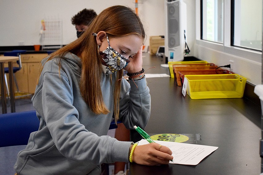 Ellie Hierholzer, an eighth grader, works on an assignment during class. Eighth graders were welcomed back to campus with a ribbon cutting for the new middle school facility.
