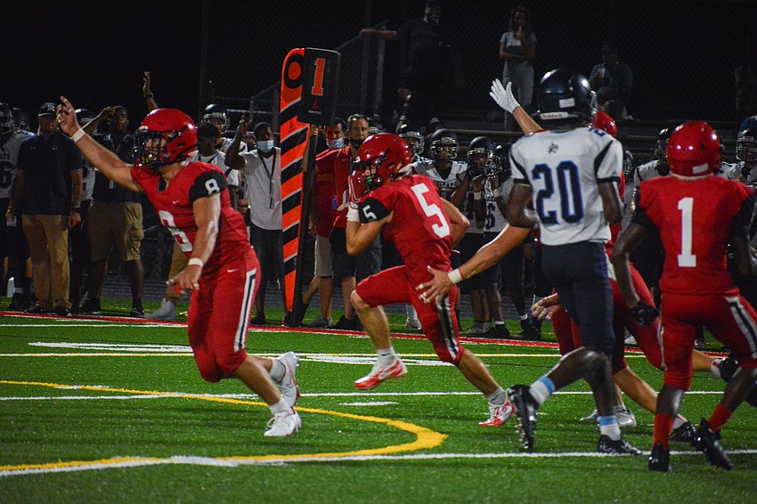 Cardinal Mooney celebrates after an interception by safety George Dramis (No. 5).
