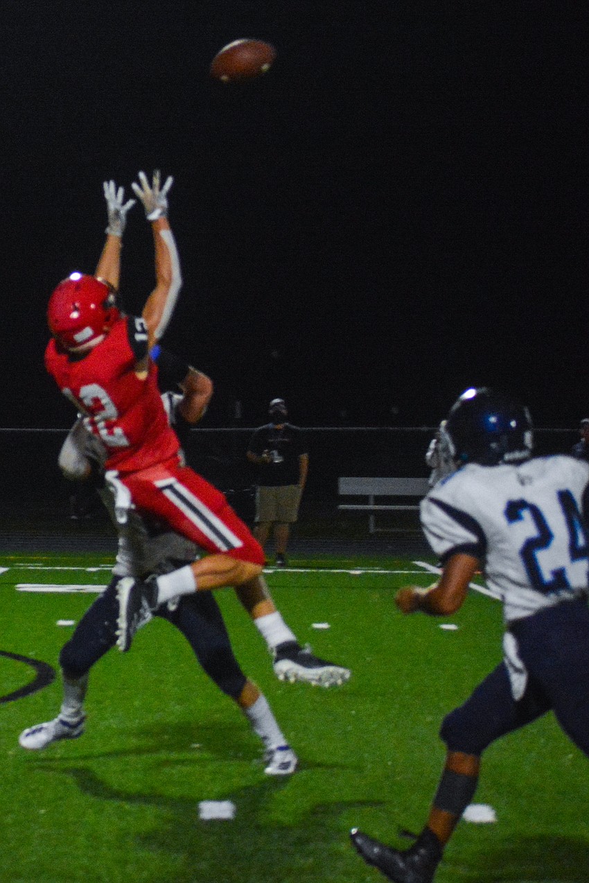 Cardinal Mooney wideout Cooper Flerlage makes a leaping catch.
