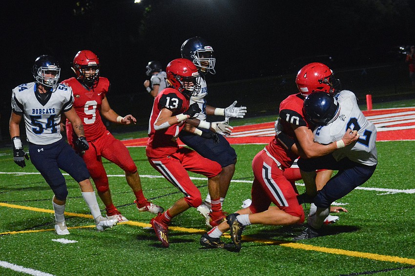 Cougars linebacker Noah Averbeck (No. 10) puts a hard hit on a North Port player.