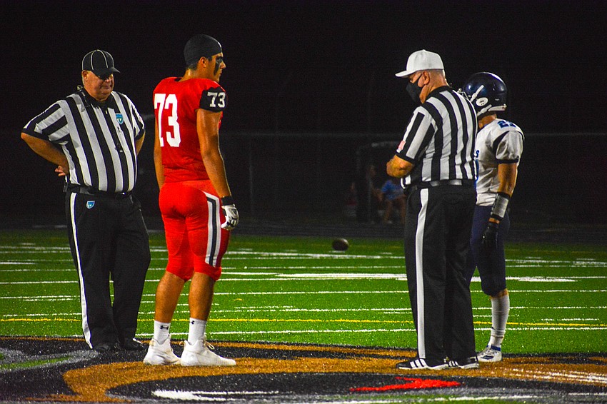 Cardinal Mooney senior Gabe Hahn (No. 73) takes the coin toss for the Cougars.