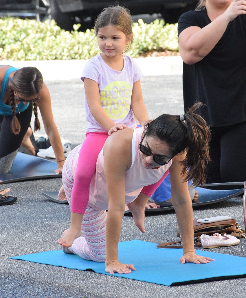 Lakewood Ranch's Lea Laney sits atop her mother, Mariana Neumann, during the workout.