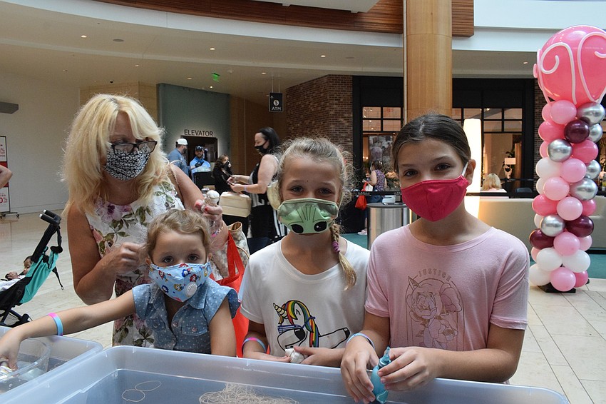 Creekwood's Angela Jessop watches her grandchildren Paige Jessop, 5, Phoebe Jessop, 8, and Polly Jessop, 10, prepare masks to be tie-dyed.