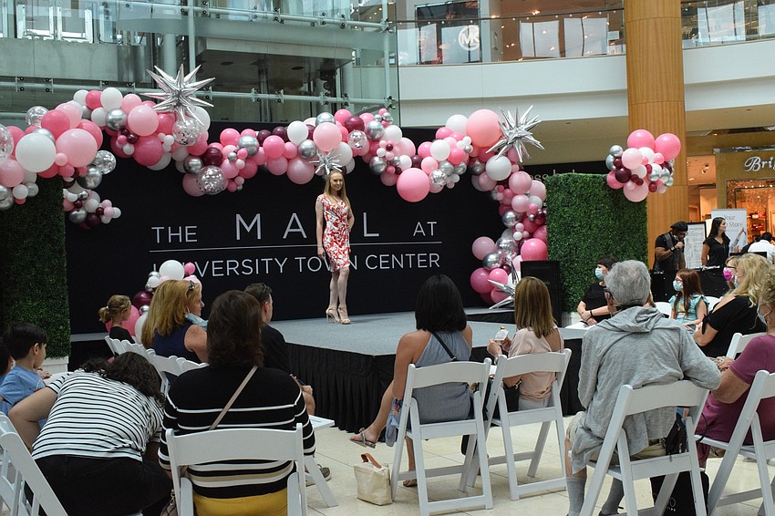 Shoppers and Women's Day Expo participants enjoy a fashion show.