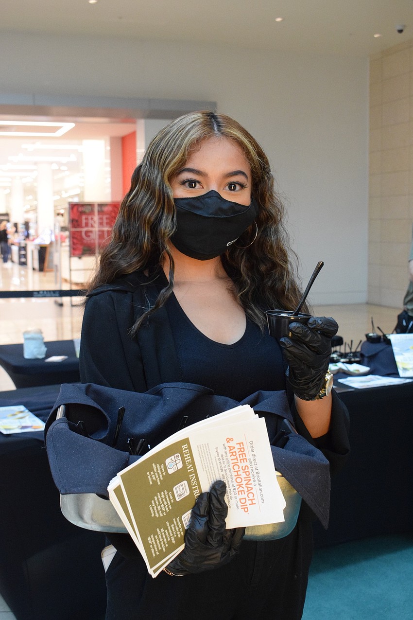 Karen Arambula, a host at Brio Tuscan Grille, gives people samples of the restaurant's tiramisu.