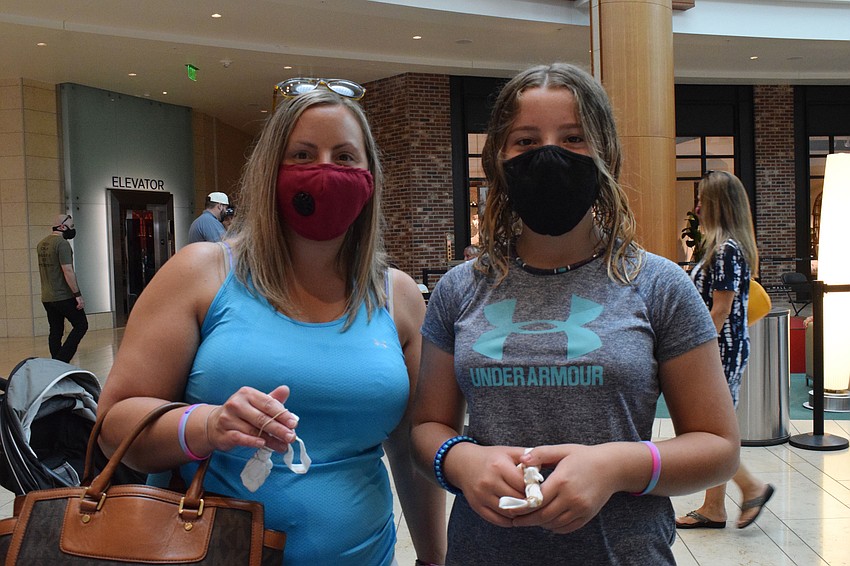 West Bradenton's Leah Hrynewicki and her 12-year-old daughter Paige Kressin put rubberbands around their masks to tie-dye.