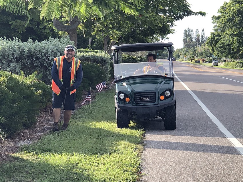 Tony Porter and Joe Brunory plant flags along GMD. Courtesy photo.