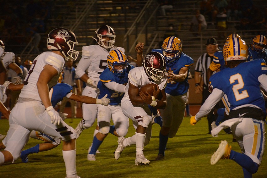 Running back Jaheim Hodo sprints through the hole.