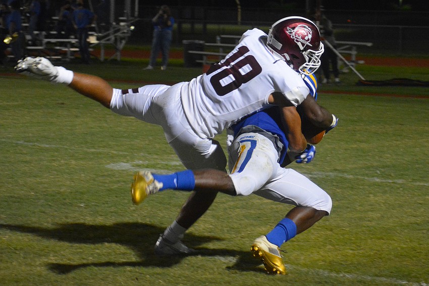 Pirates safety Isaiah Cress brings down a Tarpon wide receiver short of the goal line.