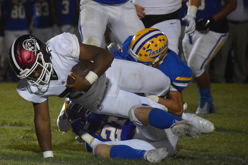 Lavontae Youmans rolls through a Charlotte tackle attempt.