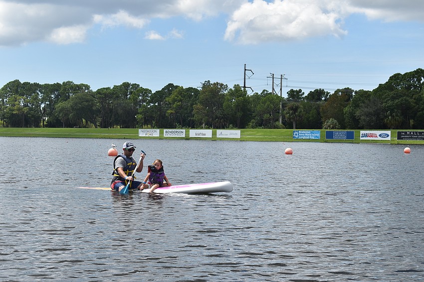 Mike Golen (left) and Laila Golen of Sarasota float away from shore on a paddleboard. Laila's favorite activity was collecting seashells.