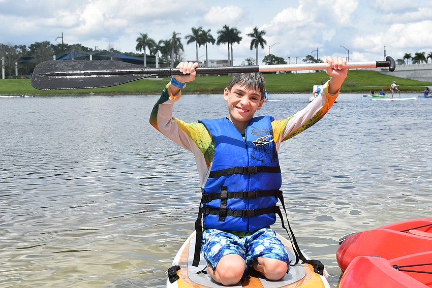Zachary Talaska of Ruskin holds his paddle triumphantly after conquering the water on his birthday.