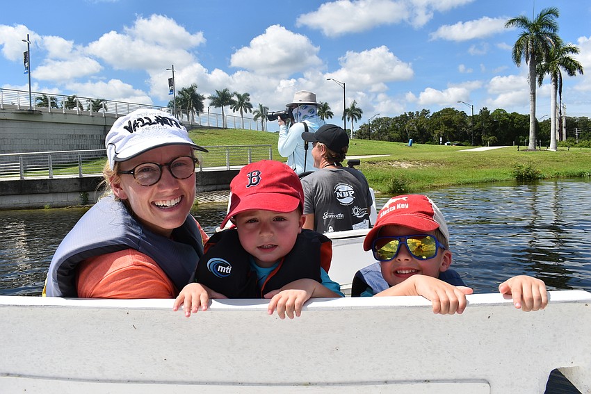 (From left)Emma Gresson of Sarasota, Aiden Cordova-Ogg and Jack Cordova-Ogg go along for the ride on a stillwater boat piloted by Gresson's partner, Meghan Farrell (in gray). The children each caught one fish Saturday.