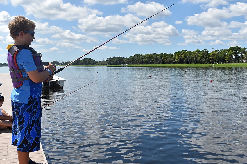 Shane Schultz, from Nokomis, tries his luck fishing in the lake at Benderson Park. He said he has caught 10 fish.