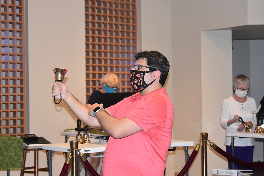 Michael Bodnyk shows his musicians how to hold the bell properly.