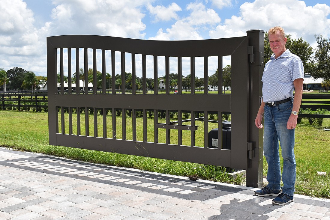 Tim Hornung stands by the Polo Ranches&#39; gate at Deer Drive and Cow Camp Lane on Thursday before it went live. Hornung is the president of the Polo Ranches HOA.
