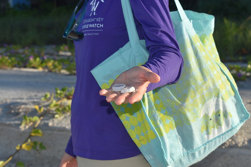 Cyndi Seamon shows all the bottle caps she found in a short radius.