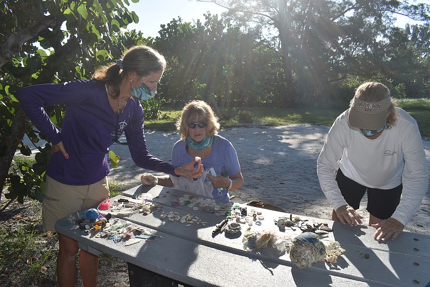 Cyndi Seamon, Laurel Phillips and Carlyn Vigil organize their trash.