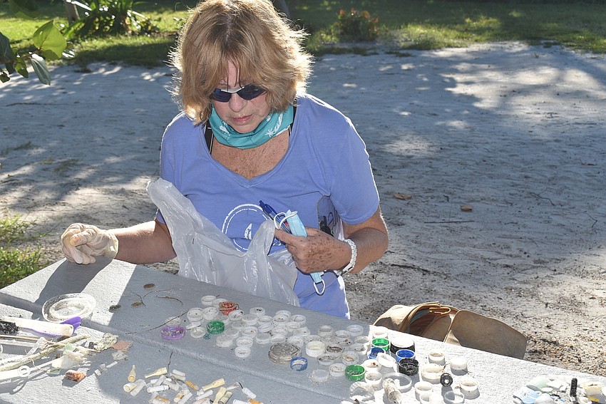 Laurel Phillips empties her bag to combine with her partner's.