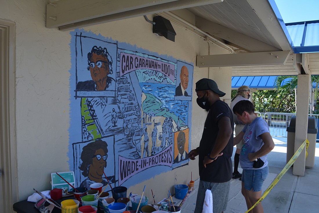 Artists Paul Lee and Julie Kanapaux paint a mural at the Lido pavilion honoring the wade-in protests against segregation at Sarasotaâ€™s beaches.