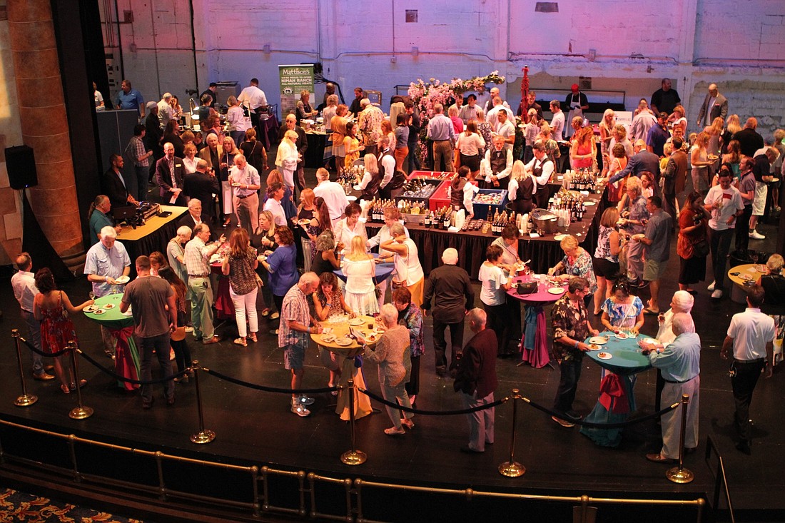 Guests of the 2019 Taste of Downtown mingle on the main stage of the Sarasota Opera House.