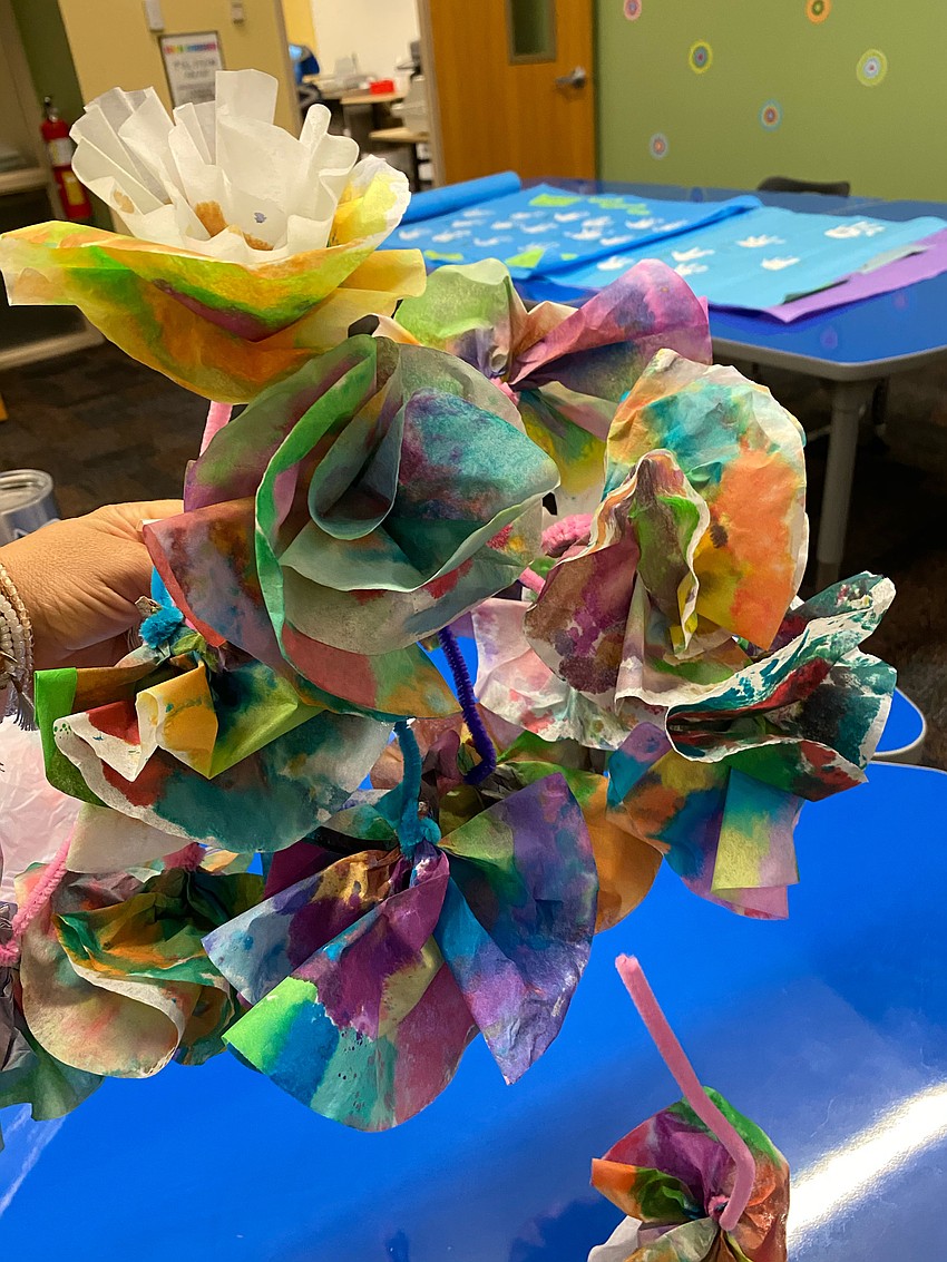 Third graders make flowers out of coffee filters. They colored them with market and sprinkled water on them to blend the colors. Courtesy photo.