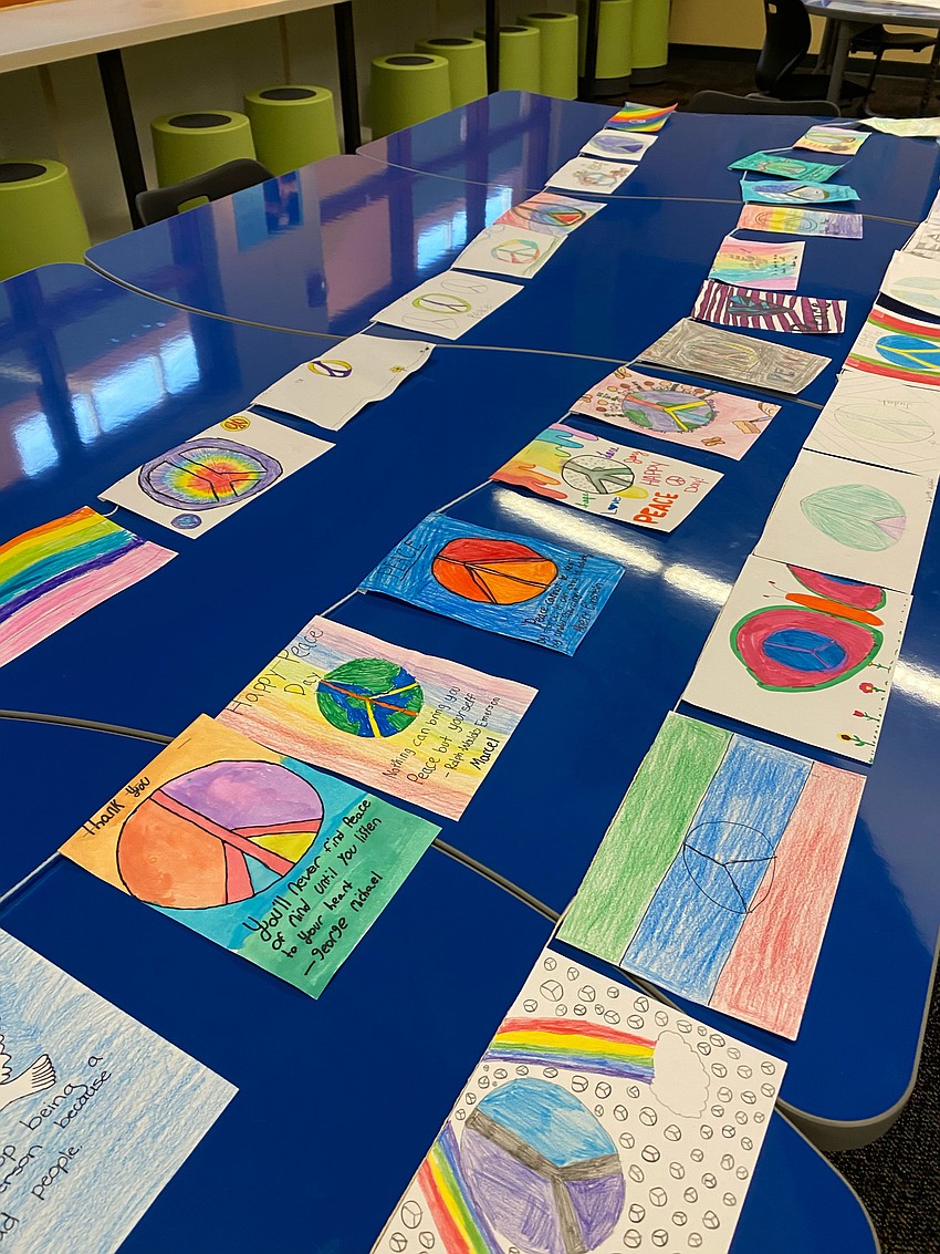 Fifth graders make peace flags. They decorated the flags to show what peace means to them. Courtesy photo.