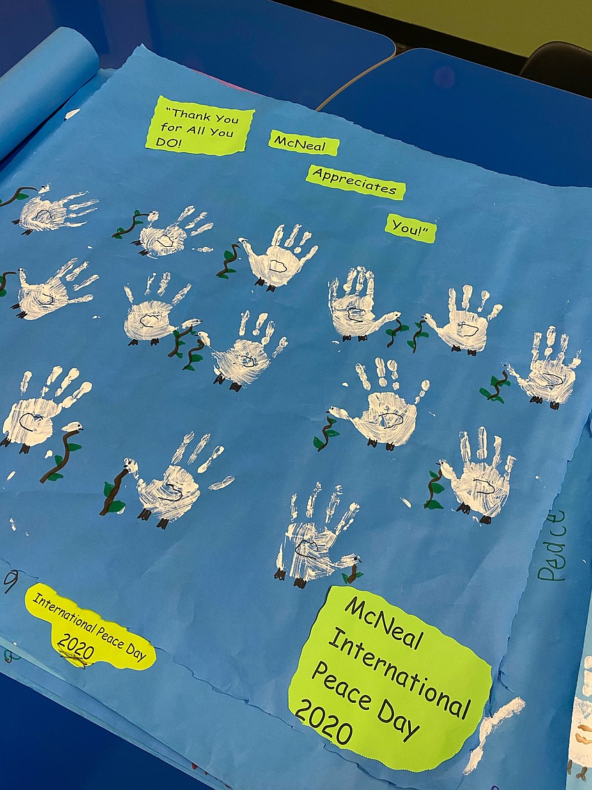 Pre-K students and kindergartners trace their hands to make them look like peace doves. Courtesy photo.