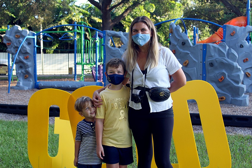 The Goetz family takes a photo by a 