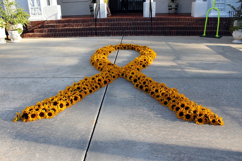 Hundreds of sunflowers are used to create a ribbon. Brynn Mechem