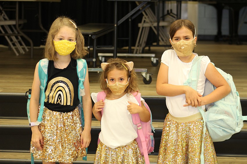 Elle Chevalier, Isla Finlay and Reese Finlay wear gold skirts, accessories and even face masks in support of the fundraiser. Photo courtesy
