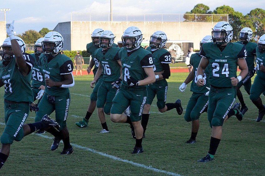 The Mustangs take the field.
