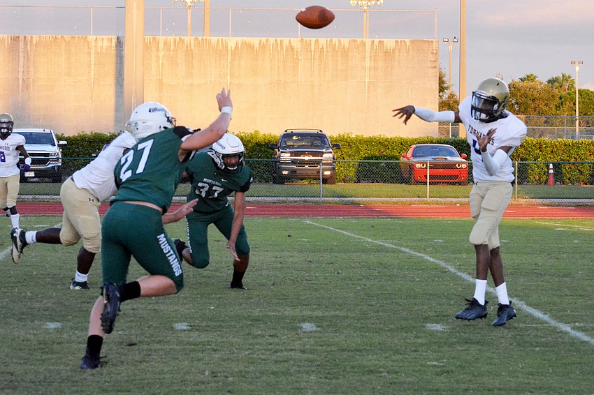 Booker senior quarterback King Winkfield throws a pass over the Lakewood Ranch defense.