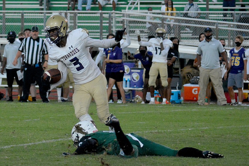 Booker senior wideout Cam'ryn Brewer spins out of a tackle.