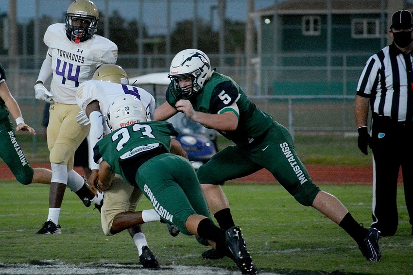Lakewood Ranch junior safety Marlowe Walker (23) drags down Booker quarterback King Winkfield.