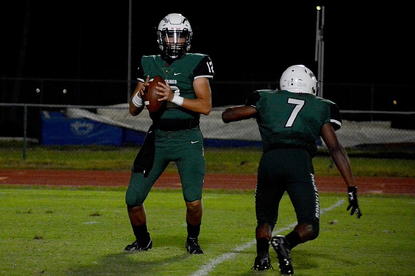 Lakewood Ranch High junior quarterback Cameron Madison (12) looks for a receiver.