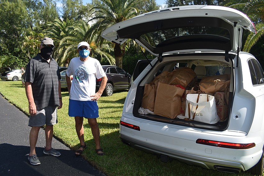 David Gorin and Paul Skversky fill up another car.