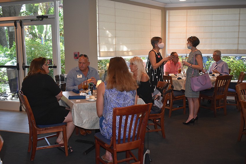 Attendees made small talk on the way to their tables, but didn't move much once they sat down.