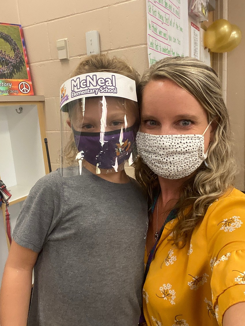 Charlotte Wells, a first grader at Gilbert W. McNeal Elementary School, celebrates Go Gold Day with Ashley Terry, the assistant principal.