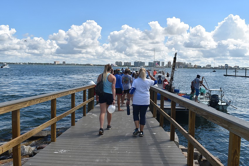 Students head to the barge to distribute clams.