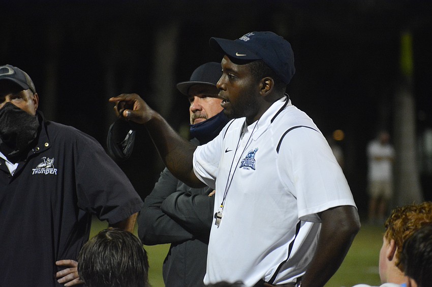 K.B. Belton talks with his team after the 43-42 loss.