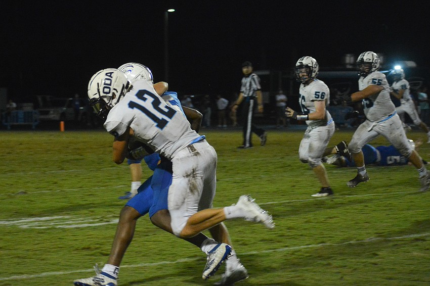 Michael Wyatt Carlton makes a tackle on a Canterbury player.