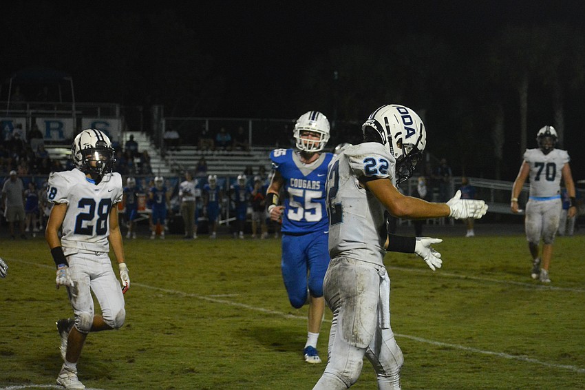 Nolan Lewellen (22) celebrates after breaking up a fourth-down pass with a hard hit.