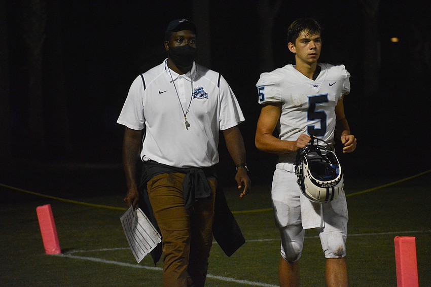 ODA Coach K.B. Belton chats with quarterback Tyler Beasley coming out of halftime.
