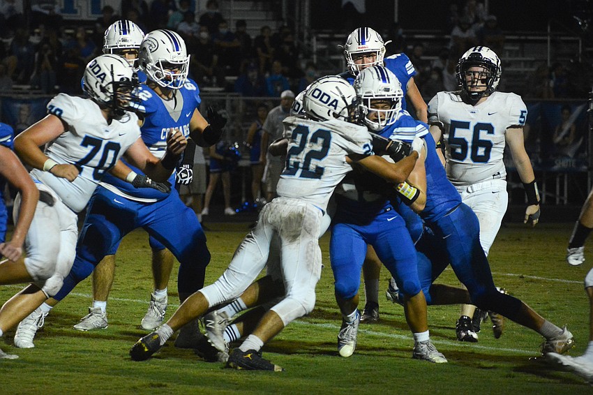 Nolan Lewellen (22) tackles a Canterbury player.