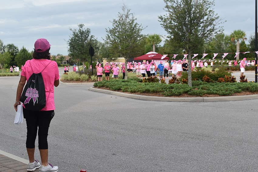Del Webb Women's Club President Ellen Lotz addresses some of the walkers who turned out for the walk-a-thon. The course was three miles long.